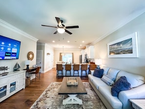Large living room open to the kitchen and dining space with breakfast bar.