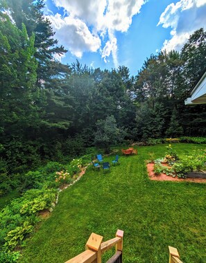 View of garden and fire pit from apartment deck/stairs