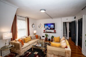 Living/Gathering Room -  60" Smart TV - Sound Bar - Board Games - Books 