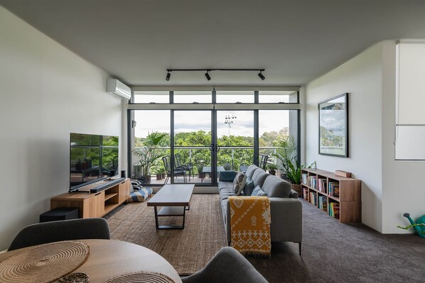 Vibrant and large living space with treeetop views