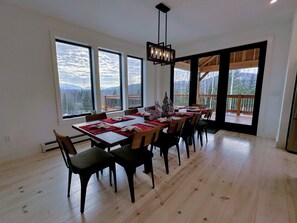 Dining area adjacent to kitchen and living room with mountain views
