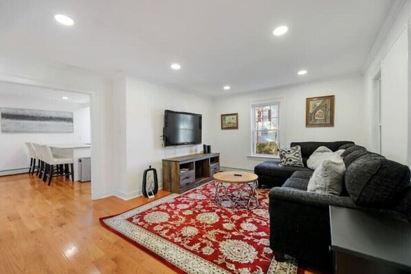 Cozy living room nestled between the oversized kitchen and four-season porch.