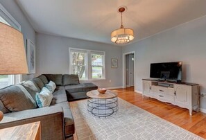Cozy living room with an oversized sofa and a smart TV.