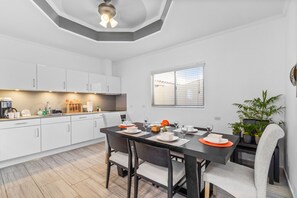 Modern and fully equipped kitchen and dinning area of the villa in Noord, Aruba - Availability of all kitchen accessories - Elite 6 persons dinning - Elegant lighting - Large amount of storage - Sufficient space to work according to your ease