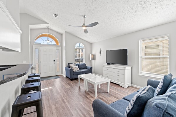 The living area is spacious and open concept into the spacious kitchen and dining areas