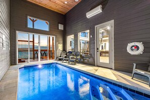 Indoor pool leading to outdoor hot tub and views