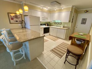 Fully stocked Kitchen with large island opens up to Living Room