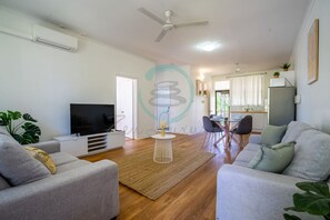 Zen Nest: Cozy  ~ Lawn ~ Minimalist - Bask in the natural light and stylish decor of our modern living room, your haven for relaxation and entertainment.