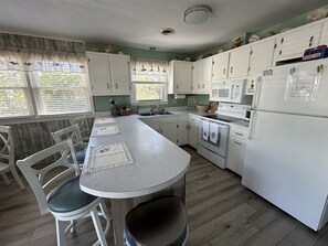 Open kitchen with bar top seating