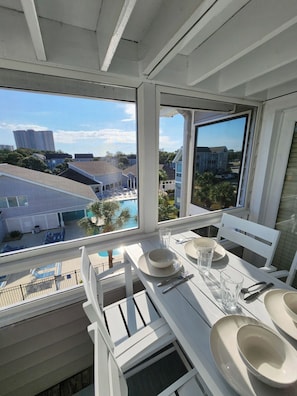 Screened-in outdoor balcony overlooking the pool