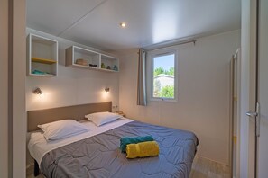 A cozy bedroom haven, complete with soft lighting and plush bedding, ensures a restful night's sleep.