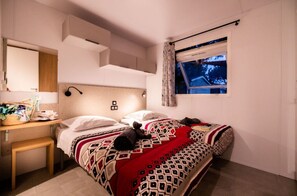 Warmly lit bedroom with soft decor, creating a comfortable and inviting atmosphere for restful nights.