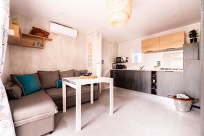 Bright and modern living space with a cozy dining area, perfect for relaxing after a day of adventure.