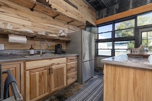 Fully stocked kitchen, coffee bar, and big windows give a view of the river