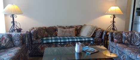 Living room with 3 couches and TV