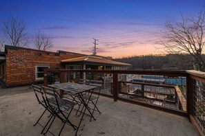 Private outdoor terrace with seating, a dining area, and a grill.