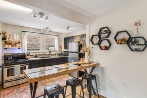 Fully equipped kitchen with barstool seating.