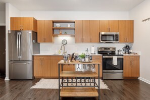 Discover a modern kitchen with sleek wooden hanging cabinets, equipped with all essentials for culinary delight. Enjoy the perfect blend of functionality and style in this inviting culinary space.