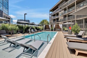 Resort style pool with cabanas and loungers