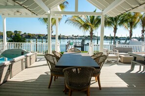 Outdoor dining, with spa to the left and pool table to the right. Relaxation all around.