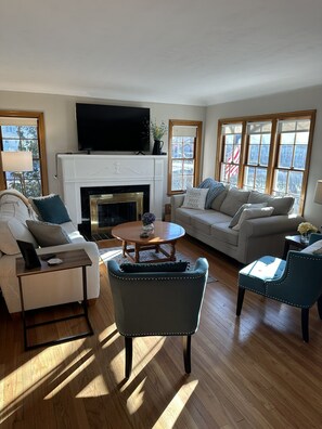 Cozy living room with plenty of seating space and tons of light!