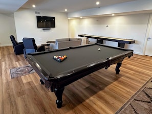 Lower level offers an entertainment space with TV, Pool Table and Shuffleboard