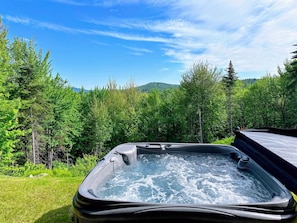 Hot tub off of the lower level walkout with goreous views