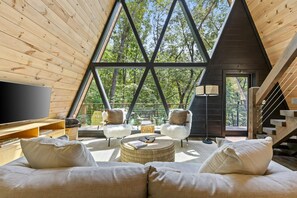 Bright and inviting, our living room features expansive windows and abundant natural light. The perfect space for cozy gatherings and relaxation!