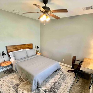 Queen room with desk & rolling chair.