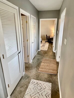 View of queen room, down the first hallway. The bathroom is the open door on the left!