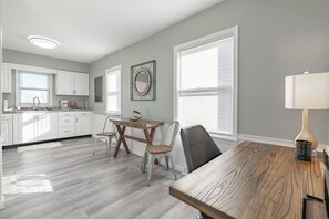 Desk/work area with rolling office chair.