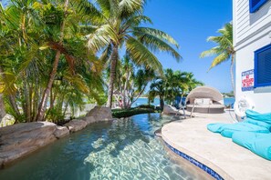 Private pool with a sun bed and bean bags for lounging under the sun. 