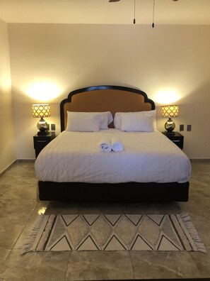 The bedroom with king size bed and high quality linens.