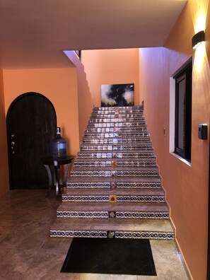 The stairs leading to the first floor, and the water station.