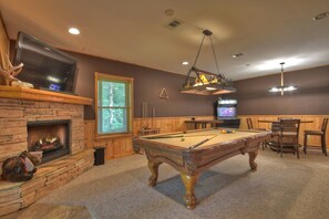 Fully loaded game room with pool table, arcade game and poker table.