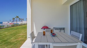 Dining table for four on the shaded patio.