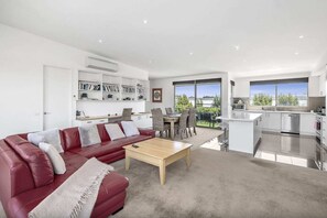 The open plan design provides comfortable lounges with a TV and gas log fire