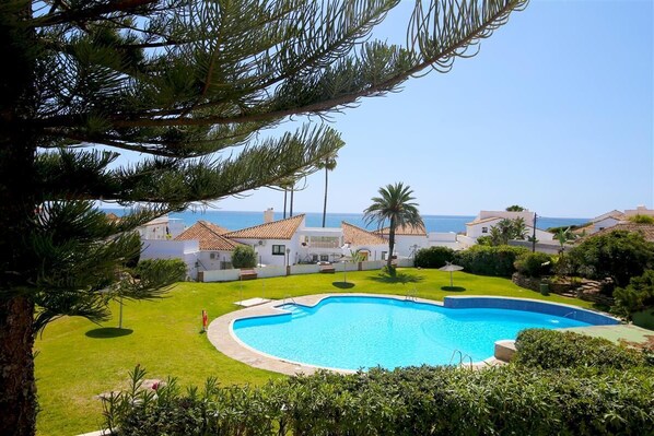 Stunning views to the pool, gardens and the sea from this property