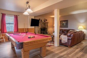 Play a game of pool in the second living area.