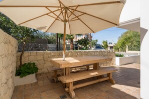 The stone fenced patio with a shaded dining area! 