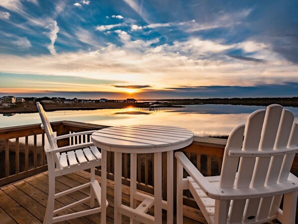 Enjoy stunning sunset views over the water from the upper balcony, where peaceful evenings and vibrant skies set the perfect tone for relaxation.