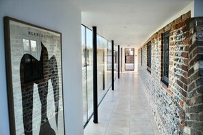 A glass walkway connect the rooms and allows stunning views across the open farmland behind. (1)