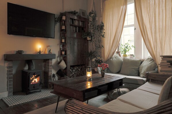 Dusk in the living room, with the woodburner on