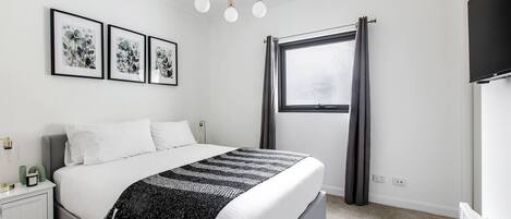 The bedroom comes with a plush queen-sized bed fronting a wall-hung TV for easy viewing.