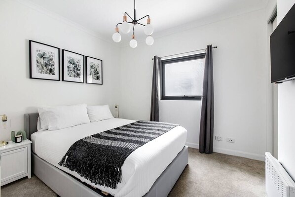 The bedroom comes with a plush queen-sized bed fronting a wall-hung TV for easy viewing.
