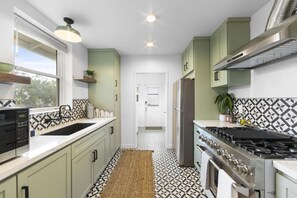 A fully stocked kitchen with plenty of counter space.