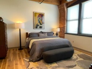 King bedroom with Brutalist-style furnishings