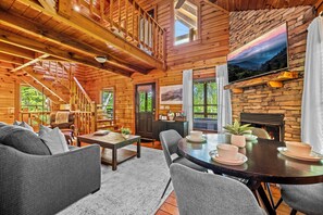 The kitchen leads into an open floor plan living room, door to deck and hot tub.