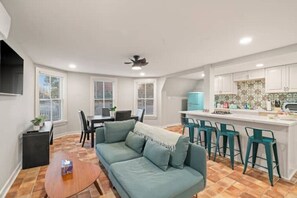 Enjoy the open-concept living area with a Smart TV and cozy couch to lounge on! 