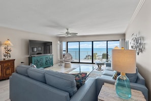 Living room with plenty of seating and very large tv